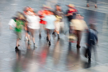 Large group of people walking in airport, travel destination in holiday