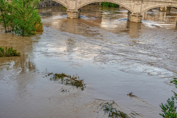 Rome, Italy Tiber river high tide water rise. Day view of high water level flooding the banks of the river crossing the Italian capital, after heavy rain.