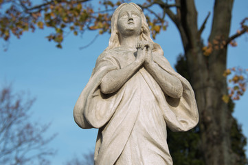 Monument and candles in the cemetery. All Saints Day in Poland.