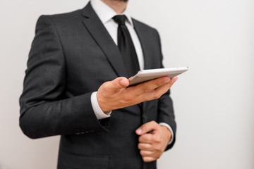 Male human wear formal work suit hold smart hi tech smartphone use one hand
