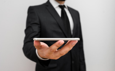 Male human wear formal work suit hold smart hi tech smartphone use one hand