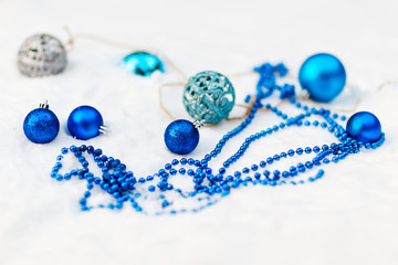 New Year's toys and balls in the snow. Christmas.