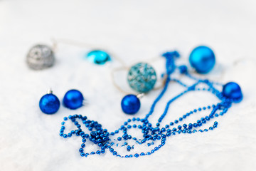 New Year's toys and balls in the snow. Christmas.