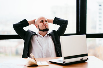 Business people. Confidence and expertise. Successful businessman sitting at office desk satisfied and relaxed