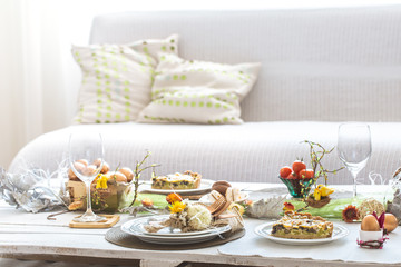 The interior of the room with a festive Easter table .