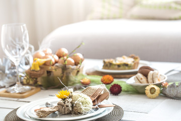 The interior of the room with a festive Easter table .