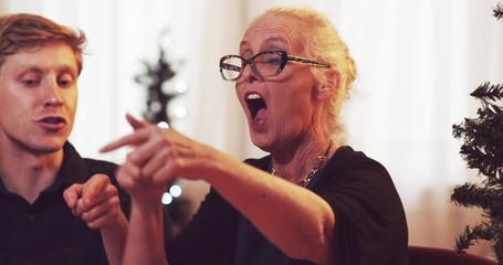 Grandma argues and yells her side in a game of cards over holidays - slow motion - shot on RED - Powered by Adobe