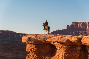 A rider silhouette seen from the back with the valley at his feet in Monument Valley, Arizona