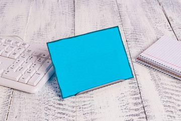 Notepaper stand on buffer wire in between computer keyboard and math sheets