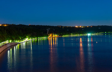 reflection of trees in lake at sunset