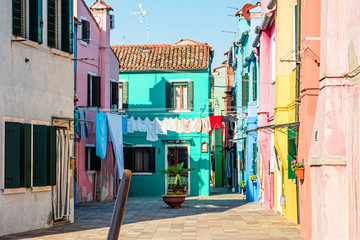 Fototapeta na wymiar Typical colorful house of Burano Island with hanging laundry at its facade.