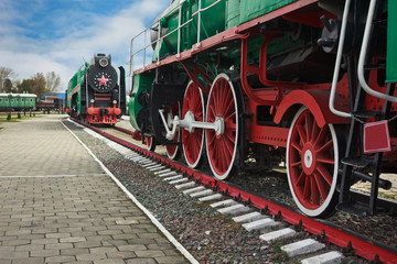 Wheels of a green Soviet-made passenger locomotive. It was made until 1940