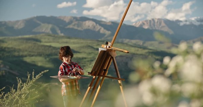 Caucasian kid dreaming of becoming an artist, creating a picture inspired by beauty of lake in mountains, learning how to draw - childhood memories, recreational pursuit 4k