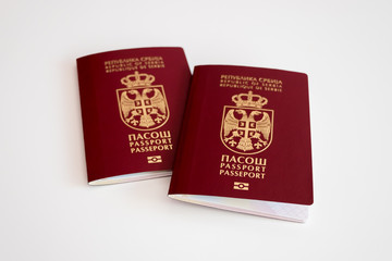 Two Serbian passports on white background, selective focus, conceptual