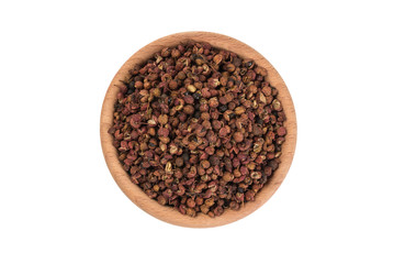 sichuan pepper in wooden bowl isolated on white background. top view. spices and food ingredients