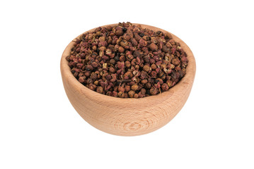 sichuan pepper in wooden bowl isolated on white background. 45 degrees view. spices and food ingredients