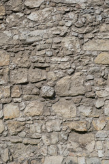 Photo of old brown and gray stone wall texture. Stone wall for background or texture.
