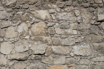 Photo of old brown and gray stone wall texture. Stone wall for background or texture.