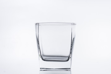 Empty glass glass for water or alcohol on a white background. Close-up photo