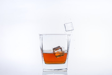 splashing, glass, whiskey, drink, alcohol, ice, beverage, cold, isolated, whisky, liquid, white, scotch, brandy, cocktail, liquor, splash, cube, shot, tea, bar, rum, bourbon, cola, alcoholic, brown  b