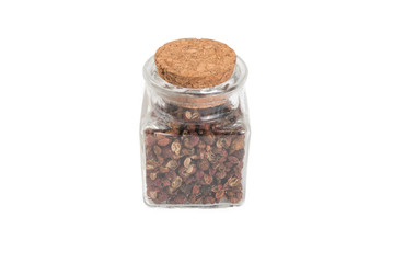 sichuan pepper in a glass jar isolated on white background. spices and food ingredients. spices and food ingredients