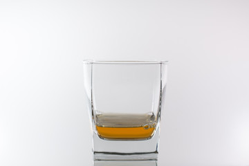 Some whiskey in a glass on a white background.