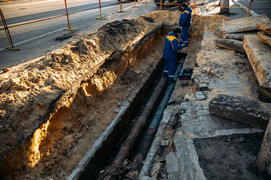 Workers repair water, drainage or sewer pipeline