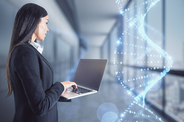 Businesswoman and glowing DNA hologram