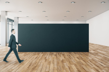 Businessman in gallery with poster