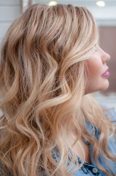 portrait of a blonde girl with curly hairstyle