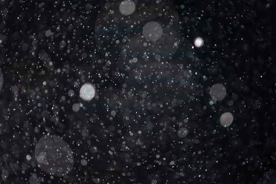 Abstract snow or rain texture on black background for overlay.