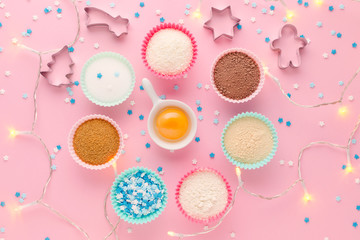ingredients like a clock, baking time concept, on pink background with garland