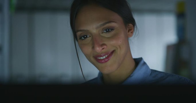 Slow motion close up of a young beautiful business woman is working with a computer in a office.