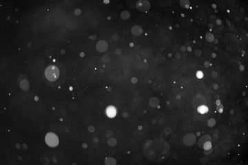 Snow or rain bokeh texture on black background