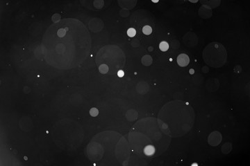 Snow or rain bokeh texture on black background