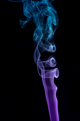 Abstract of colored blue and purple smoke with a black coloured background