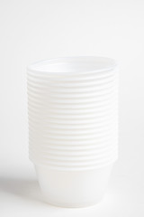 A stack of small plastic container for specimen medical laboratory testing set on a white background.