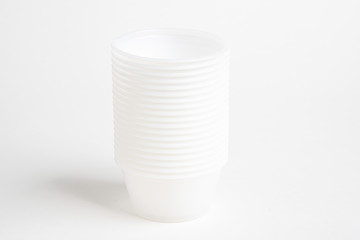 A stack of small plastic container for specimen medical laboratory testing set on a white background.
