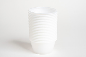 A stack of small plastic container for specimen medical laboratory testing set on a white background.