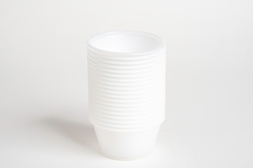 A stack of small plastic container for specimen medical laboratory testing set on a white background.