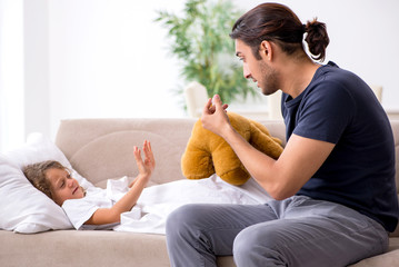 Father taking care of his ill daughter