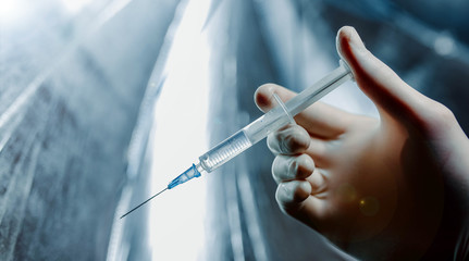 syringe with an injection in the hands of a doctor. concept.