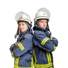 Young couple of firefighters with folded arms standing back-to-back wearing uniform and helmets
