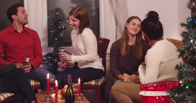 Pan across friends sharing Christmas together at a holiday party - slow motion - shot on RED