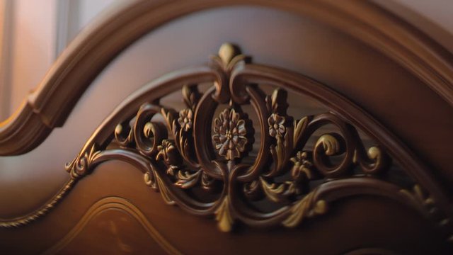 The back of a luxury expensive bed with a beautiful and impressive patterned carving