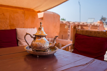 Traditional Moroccan mint tea served in a silver tea pot on a riad rooftop in Marrakech