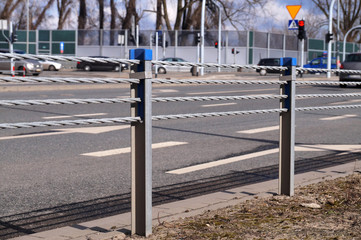 Close-up view of posts and ropes. Cable barrier, also called guard cable or wire road safety barrier, is increasingly used road safety.