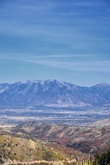 Panoramic view of Wasatch Front Rocky Mountains from the Oquirrh Mountains with fall leaves, by Kennecott Rio Tinto Copper mine, Utah Lake and Great Salt Lake Valley. Utah, America.