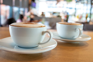 A cup of fragrant cappuccino coffee. In the morning in the cafe, coffee makes the body refreshed.