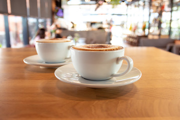 A cup of fragrant cappuccino coffee. In the morning in the cafe, coffee makes the body refreshed.